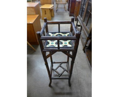 A Victorian Aesthetic Movement bamboo jardiniere stand, inset with Minton tile, manner of Libertys 