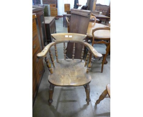 A Victorian elm and beech smokers bow chair 