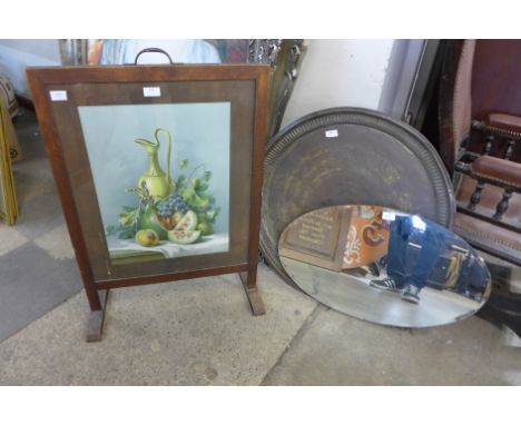 A fire screen, a circular brass table top and an oval mirror 