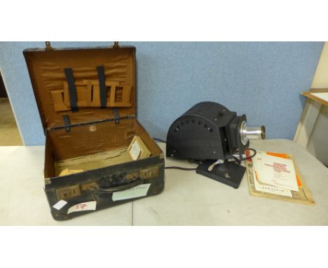 A Johnson Optiscope slide projector in case 