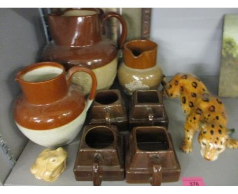 A Bourne Denby stoneware jug and others, a Cadbury stoneware jug and four chocolate mugs, a bohemian china model of a leopard