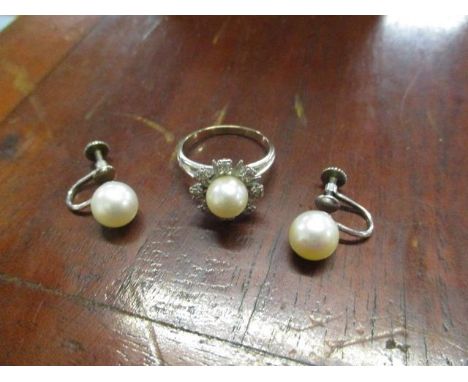A pair of white gold coloured metal screw earrings, set with a single pearl, stamped 14k, 8mm dia, 3g, and a white gold colou