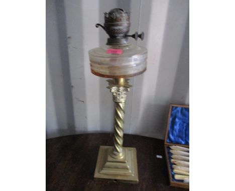 A Victorian oil lamp having a brass Corinthian column and a stepped base 