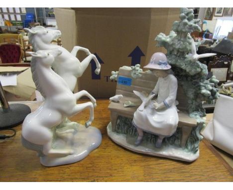 A Nao figurine of a girl seated on a bench, and a Spanish figurine of two rearing horses 