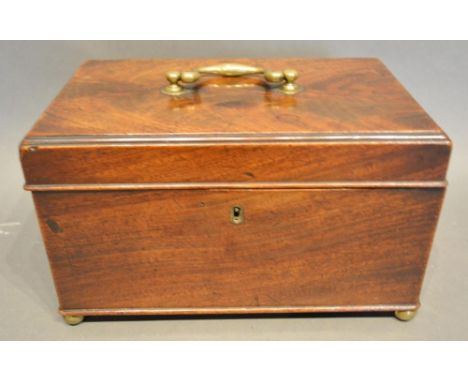 A George III Mahogany Tea Caddy, the hinged cover with brass handle enclosing a fitted interior with blending bowl, all raise