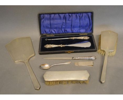 A Birmingham Silver Backed Three Piece Dressing Set, together with a silver handled shoe horn, a button hook in fitted case, 