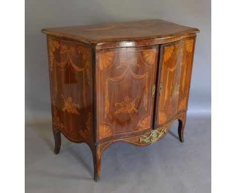 A 19th Century French Marquetry Inlaid And Gilt Metal Mounted Serpentine Commode, with two doors above a shaped apron, raised