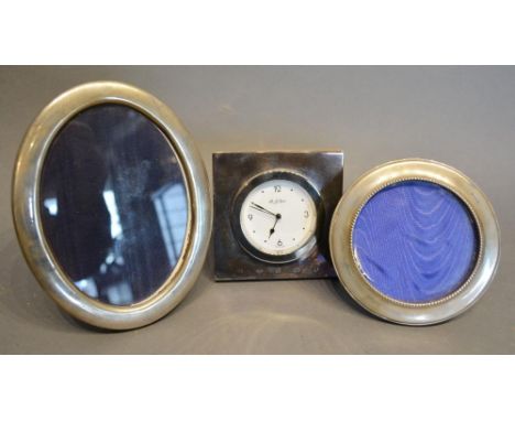 A Silver Cased Table Clock of Square Form, 10cm square, together with a silver oval photograph frame, 16.5 x 13cm, and Birmin