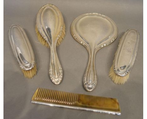 A Birmingham Silver Backed Five Piece Dressing Table Set comprising hand mirror, three brushes and a comb 