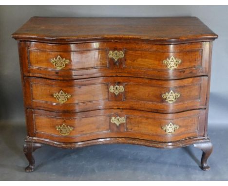 An 18th Century Oak Serpentine Commode, the moulded top above three drawers with brass handles and escutcheons raised upon ca