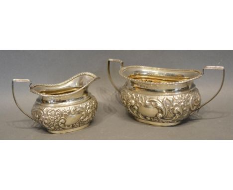 A Birmingham Silver Two Handled Sucrier with embossed decoration, together with a matching cream jug, Birmingham 1907, 12oz 