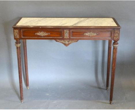 A French Mahogany Gilt Metal Mounted Console Table, the marble inset top above a gilt metal mounted frieze, raised upon turne