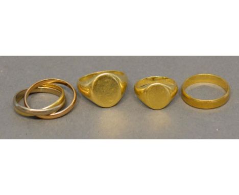 An 18 Carat Gold Signet Ring, together with another similar, two 18 carat gold band rings, 24.3 grammes 