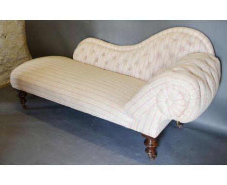 A Victorian Chaise Longue, the button scroll end raised upon turned legs, brass caps and castors, 173cm long 