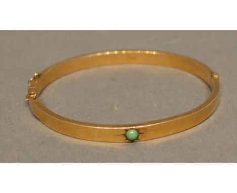 A 9 Carat Yellow Gold Bangle set with turquoise, 6.4 grammes 