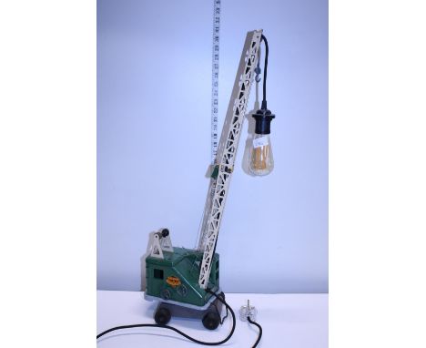 A child's tin plate crane toy converted into a table lamp in working order, h75cm shipping unavailable 