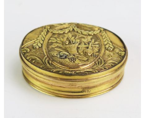 A late 18th / early 19th century gilt copper patch box, of oval outline, the hinged lid decorated with basket of flowers, rak