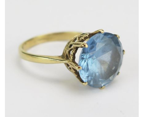 A Blue Topaz Solitaire Dress Ring in a precious yellow metal setting, 11.3mm stone, size K.5, unmarked, KEE tests as 9ct, 3.2