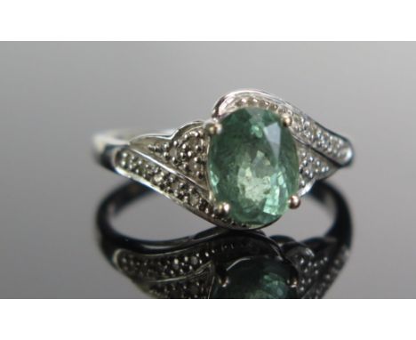 An 18ct White Gold, Tourmaline and Diamond Ring, 8.1x6.2mm principal stone, size M.75, 4.05g 