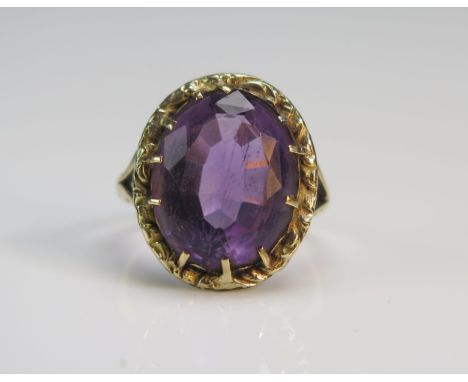 An Antique Amethyst Ring in a precious yellow metal split shank setting, 19.8x16.5mm head, size J.75, KEE tests as 14ct, 5g. 