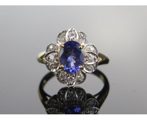 An 18ct Gold, Tanzanite and Diamond Cluster Ring, c. 8.5mm principal stone, 15.35x14/4mm head, size N, hallmarked, 5.05g 