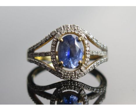 An 18ct Gold, Sapphire and Diamond Cluster Ring, 8.1x6mm principal stone, size N, hallmarked, 4.72g 
