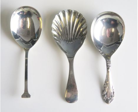 three twentieth century silver caddy spoons, various makers and dates, total weight of silver 38gms, 1.25ozs 