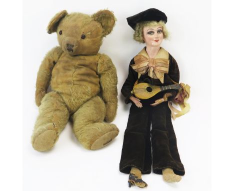 A Musical Boudoir Doll with painted composite face and hands playing a bowl backed mandolin (60cm) and vintage mohair articul