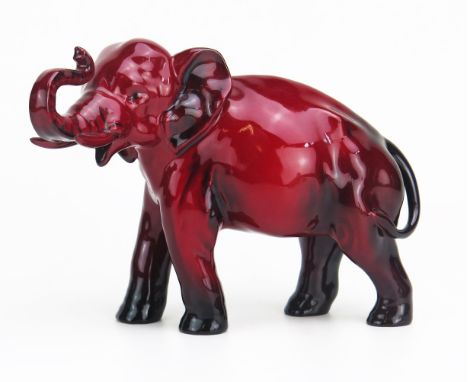 A Royal Doulton flambé model of an elephant, with raised trunk, 22cm long. 