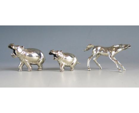 A silver model of a hippopotamus, stamped marks, 8cm long, another similar smaller model 6cm long and a silver model of a pon