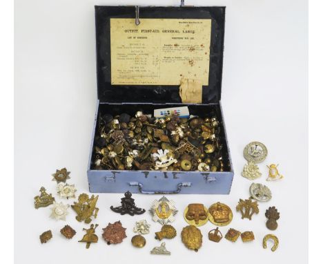 An extensive  collection of assorted army cap badges, buttons, contained in a British army First-Aid box. 