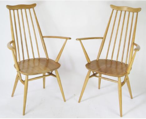 A pair of Ercol Goldsmith carver chairs, with solid seats on turned under framing. (2). 