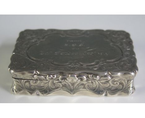 A Victorian silver snuff box, maker Edward Smith, Birmingham, 1860, inscribed, of rectangular outline, with chased foliate an