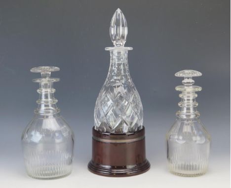 A 19th century glass decanter with triple ring neck and mallet shape, 23.5cm high, another similar decanter and stopper, and 