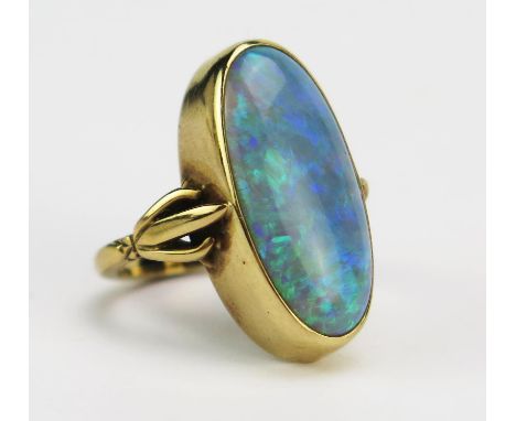 A 9ct Gold and Opal Dress Ring displaying a good range of greens and blues, c. 19.3x8.6mm rub over set stone, size G, stamped
