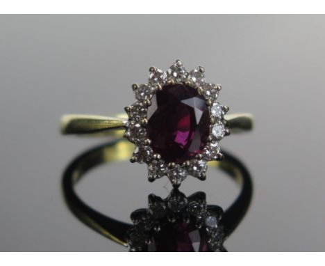 An 18ct Gold, Ruby and Diamond Cluster Ring, 7.5x6.3mm principal stone, 12.46x10.5mm head, size N.5, hallmarked, maker M.B Co