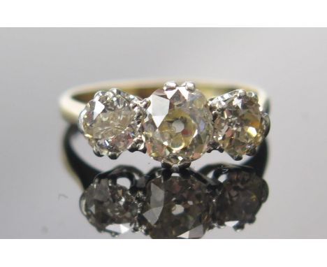 An Old Cut Diamond Three Stone Ring in a high carat precious yellow metal setting, c. 6.2x5.4mm principal stone, size K.5, 2.