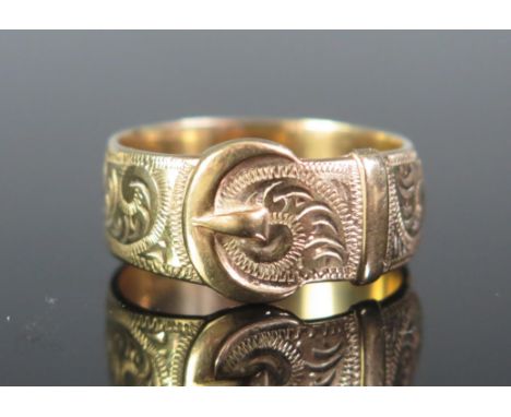 A 9ct Gold Buckle Ring with chased foliate scroll decoration, 11.4mm wide buckle, size U.5, stamped 375, 7.48g 