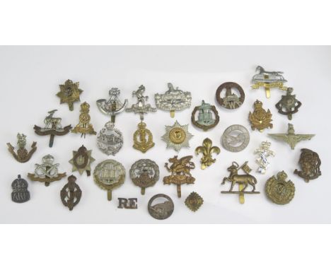 A collection of British army cap badges including South Wales Borderers, Buffs, Royal west Kent, RAMC&lt; REME and others. 