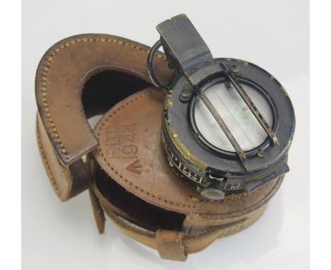 A British army issue hand held compass contained in its leather case. 