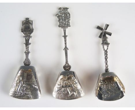 Two Dutch silver and one plated caddy spoons, with embossed figural decorated bowls, and assorted decorative terminals, total