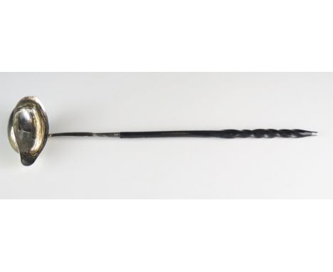 A George III silver toddy ladle all marks worn, London, 1799, mounted on a baleen spiral twist handle. 38cm long. 