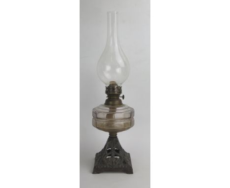 A Victorian Oil Lamp with a slice cut glass reservoir and on  a pierced cast iron base decorated with anchors 