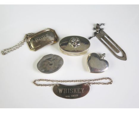 A mixed collection of silver wares, various makers and dates, includes wine and spirit labels, patch boxes, heart-shapes scen