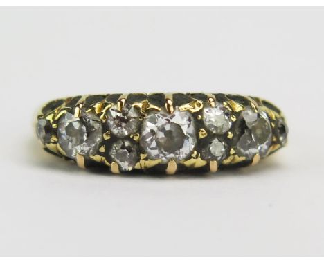 A Victorian 18ct Gold and Diamond Ring, c. 3.5mm principal old cut stone, flanked by c. 3mm stones and with six smaller, size