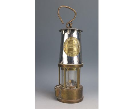 A brass and metal miners lamp of traditional design, 25cm high. 