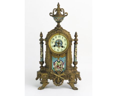 A late 19th century gilt metal and champlevé enamel mantel clock, of arched outline with urn finial, having an 8cm Arabic cha