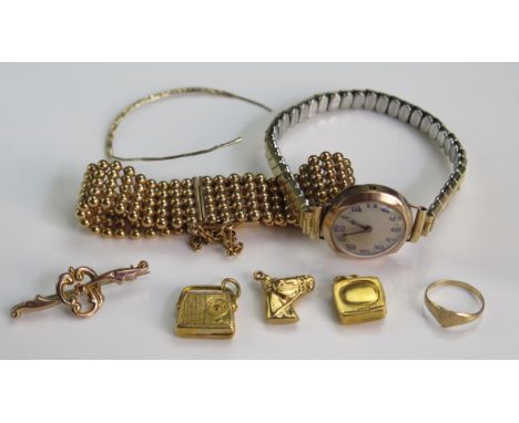 Three 9ct Gold Charms (hallmarked, 3.6g), a 9ct gold brooch (.89g), 9ct gold baby's ring (size E, .62g), damaged 9ct gold wat