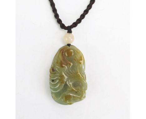 A Chinese carved jade pendant, decorated with an eagle to one side and a tree to the other, 4.5cm long. 