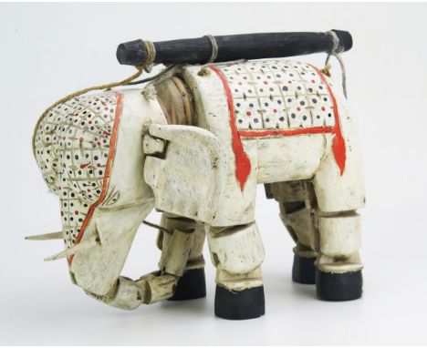 An Indian polychrome decorated wood elephant puppet, with hinged head, ears and legs. 34cm long. 